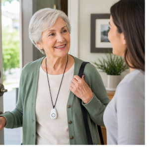 Older adult wearing an emergency pendant while talking with a family member at home